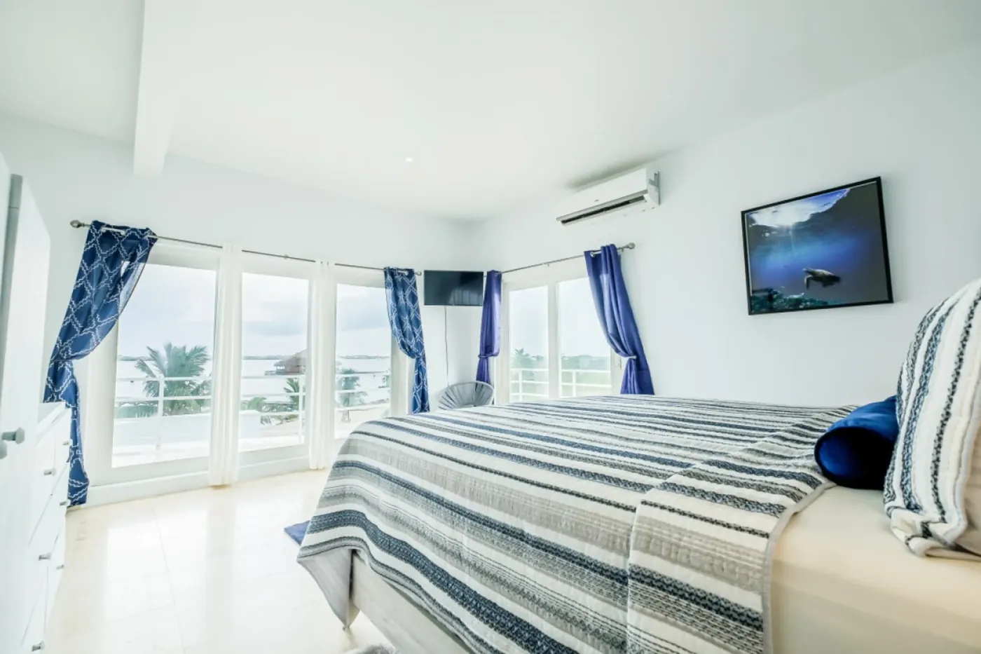 Corner bedroom at Fox Villa Belize with wraparound balcony and lagoon views