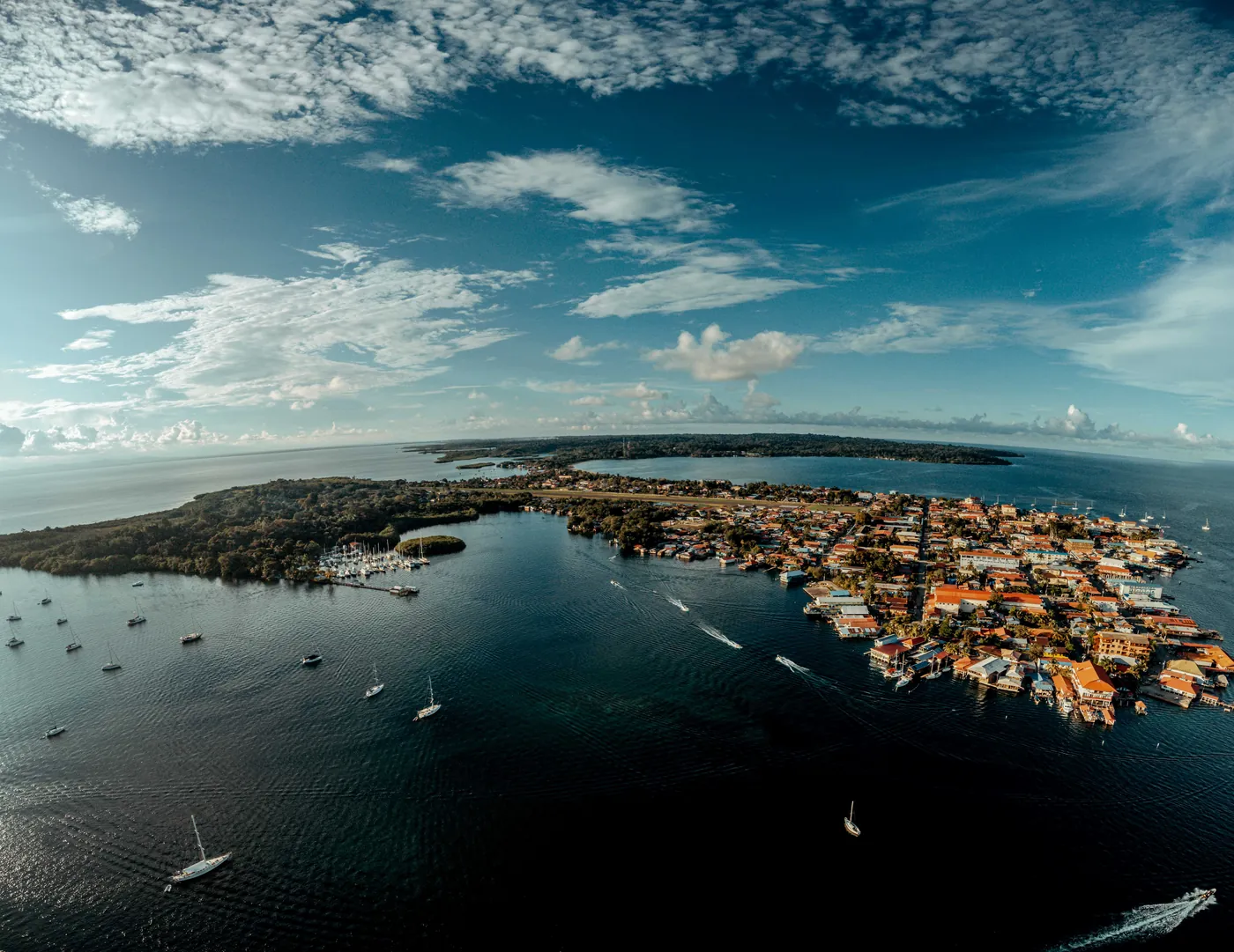 Aerial view of San Pedro town on Ambergris Caye, Belize, surrounded by boats and calm Caribbean water